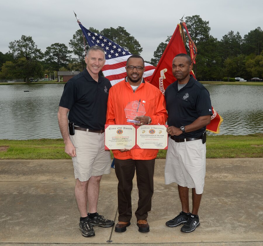 Anthony Simmons, support services supervisor/Pass and ID supervisor, Marine Corps Logistics Base Albany, accepts his award and title as the base’s newest Supervisor of Year recipient. The annual ceremony, which was held at Boyett Park, March 27, celebrated MCLB Albany's 2014 Employee Recognition Day.