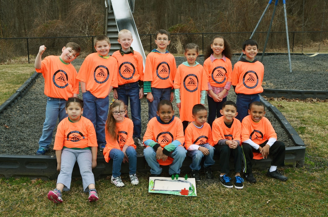 First graders in Courtney Freeman’s class at Russell Elementary School show off their new “future marathoner” T-shirts from the Marine Corps Marathon office. The class partnered with Mark Williams from the MCM office to design a running path around the playground for their schoolmates. 