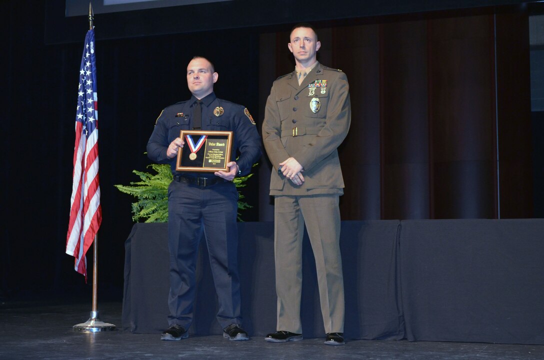 Officer John Covey, left, of the Marine Corps Base Quantico Provost Marshal Office, stands with Provost Marshal Maj. Justin Powell during an award ceremony on March 18 that recognized 21 police officers from Prince William County for valor. 