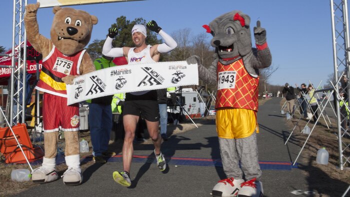 James "Jimmy" Sosinski from Haymarket, Virginia crosses the finish line of the 17.75K race in Prince William County, Virginia March 28, 2015. Sosinski completed the race first with a time of one hour, nine minutes and five seconds.