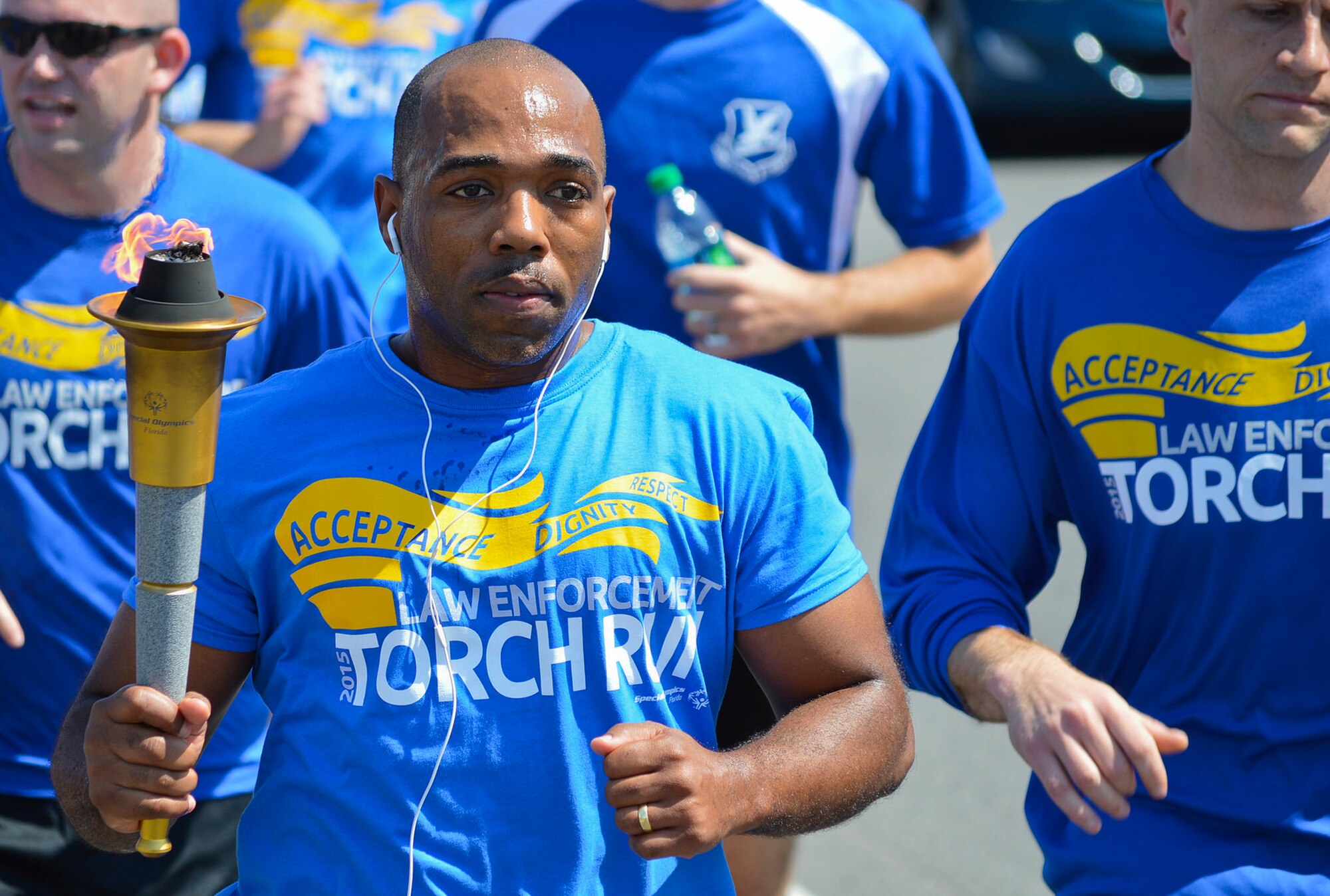 Chief Master Sgt. Samel Brown, 96th Security Forces Squadron, carries the official torch during the Law Enforcement Torch Run for Special Olympics Florida March 25 in Fort Walton Beach, Fla.  More than 20 security forces Airmen participated in the event running 5.25 miles and raising $356.  The 1,500 mile event spans across 67 Florida counties with more than 300 law enforcement runners.  The money raised goes to support Special Olympic athletes.  (Courtesy photo)