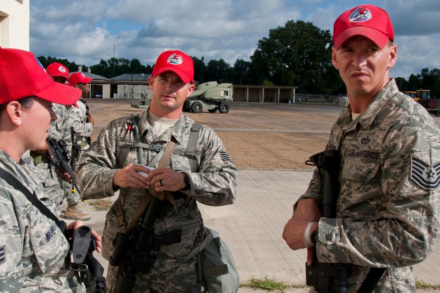 U.S. Air Force Staff Sgt. Kenneth McMillen, (center) who is a structural carpenter assigned to the 307th RED HORSE Squadron, instructs a group of Airmen on proper procedures for clearing buildings during a training exercise at Barksdale Air Force Base, La., Sept. 10, 2014. McMillen, who is also a Bowie County Sheriff’s Deputy, has been credited with saving the life of a woman in a house fire on March 9, 2015. (U.S. Air Force photo by Master Sgt. Jeff Walston/Released)