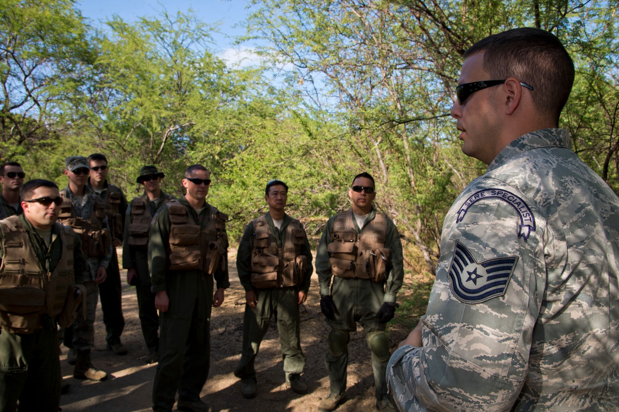 Tech. Sgt. Jeffrey Ray, a Survival Evade Resist and Escape specialist for the 15th Operational Support Squadron, gives a safety briefing to Airmen from the 15th Wing during SERE combat survival training on Joint Base Pearl Harbor-Hickam, Hawaii, March 26, 2015. During the training Airmen are required to demonstrate their ability to conceal their location, evade opposition forces, and practice proper recovery procedures. (U.S. Air Force photo by Tech. Sgt. Aaron Oelrich/Released) 