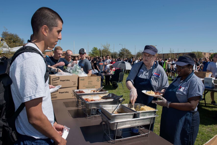 Connie Gray and Stakevia Palmer, Sheppard Air Force Base, Texas, 82nd Training Wing food service cooks, prepare meals for Airmen and families at the base Spring Picnic March 28, 2015. The food service staff fed more than 2,400 people at the picnic. (U.S. Air Force photo by Senior Airman Kyle Gese)