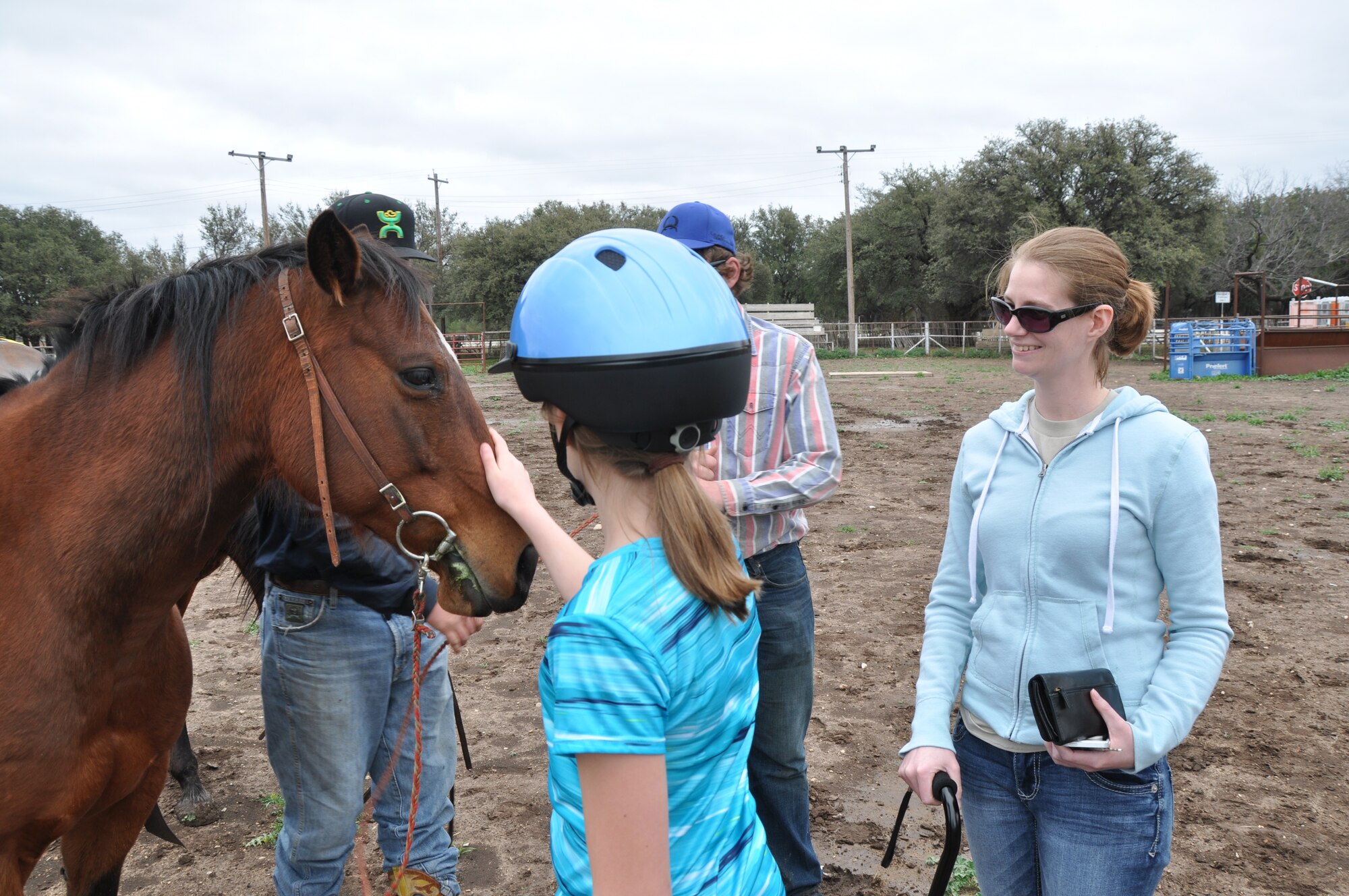 CHRISTOVAL, Texas – Master Sgt. Amy C. Dotson, 316th Training Squadron instructor, watches her daughter Fiona M. Dotson pet a horse after a riding session at Adam’s Arena March 18. Dotson and her daughter started to ride together when they were stationed in Germany several years ago. (U.S. Air Force photo/ Senior Airman Joshua Edwards)
