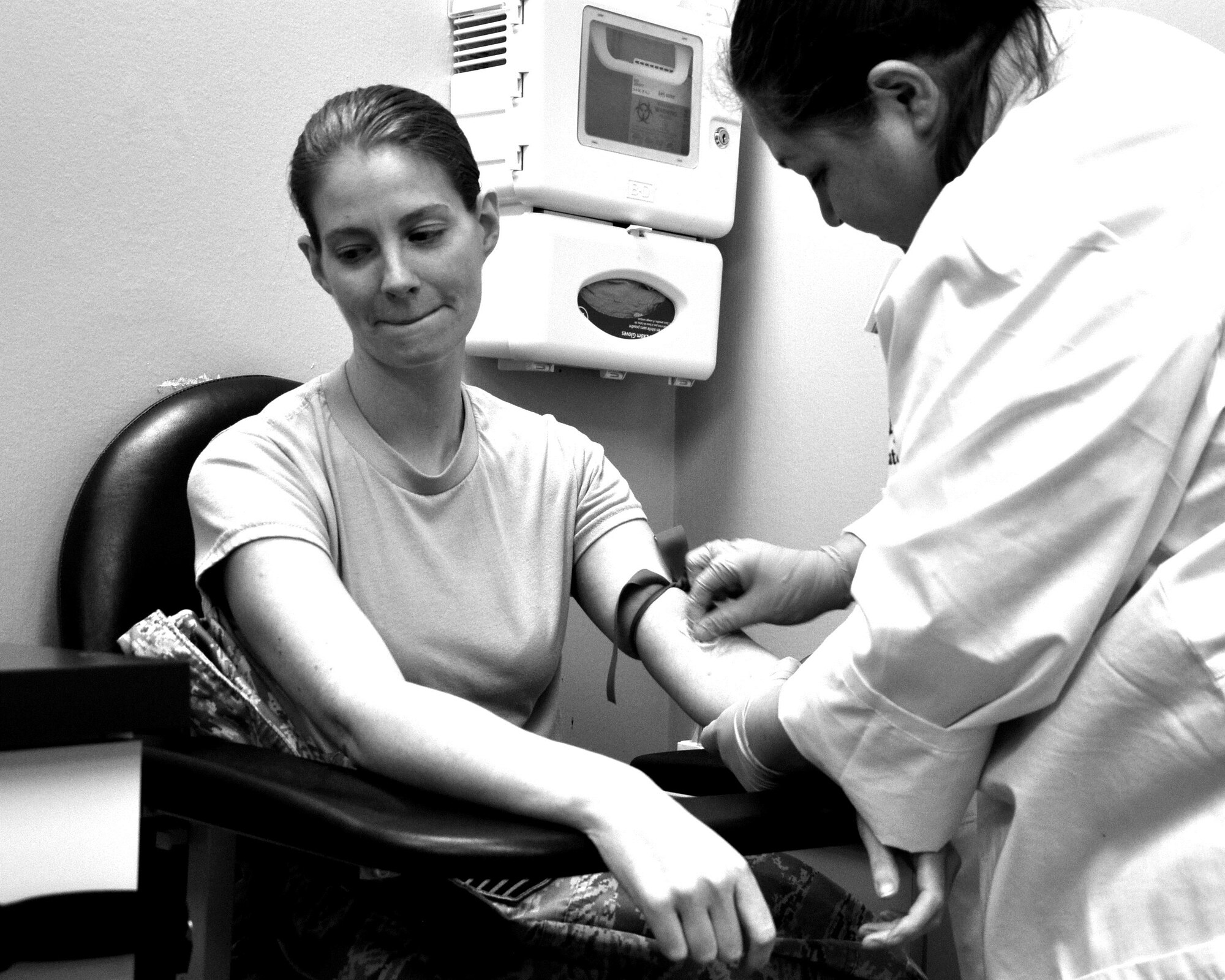 SAN ANGELO, Texas – Sonia N. Mills, West Texas Medical Associates laboratory technician, cleans 316th Training Squadron instructor, Master Sgt. Amy C. Dotson’s arm before drawing her blood at WTMA March 9. Dotson has had several tests and examinations to help her monitor the multiple sclerosis she has. (U.S. Air Force photo/ Senior Airman Joshua D. Edwards)