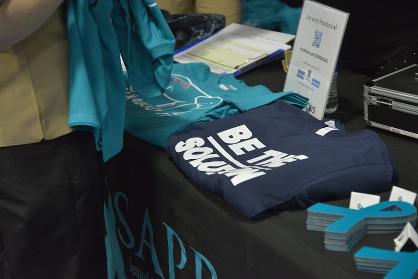 T-shirts and magnets were sold to Naval Nuclear Power Training Command staff and students at the third annual presentation of "Can I Kiss You?" in Goose Creek, SC on March 18, 2015. The goal of the event was to raise funds and sexual assault awareness amongst the attendees. (US Navy Photo by Electrician's Mate Jett Supler)