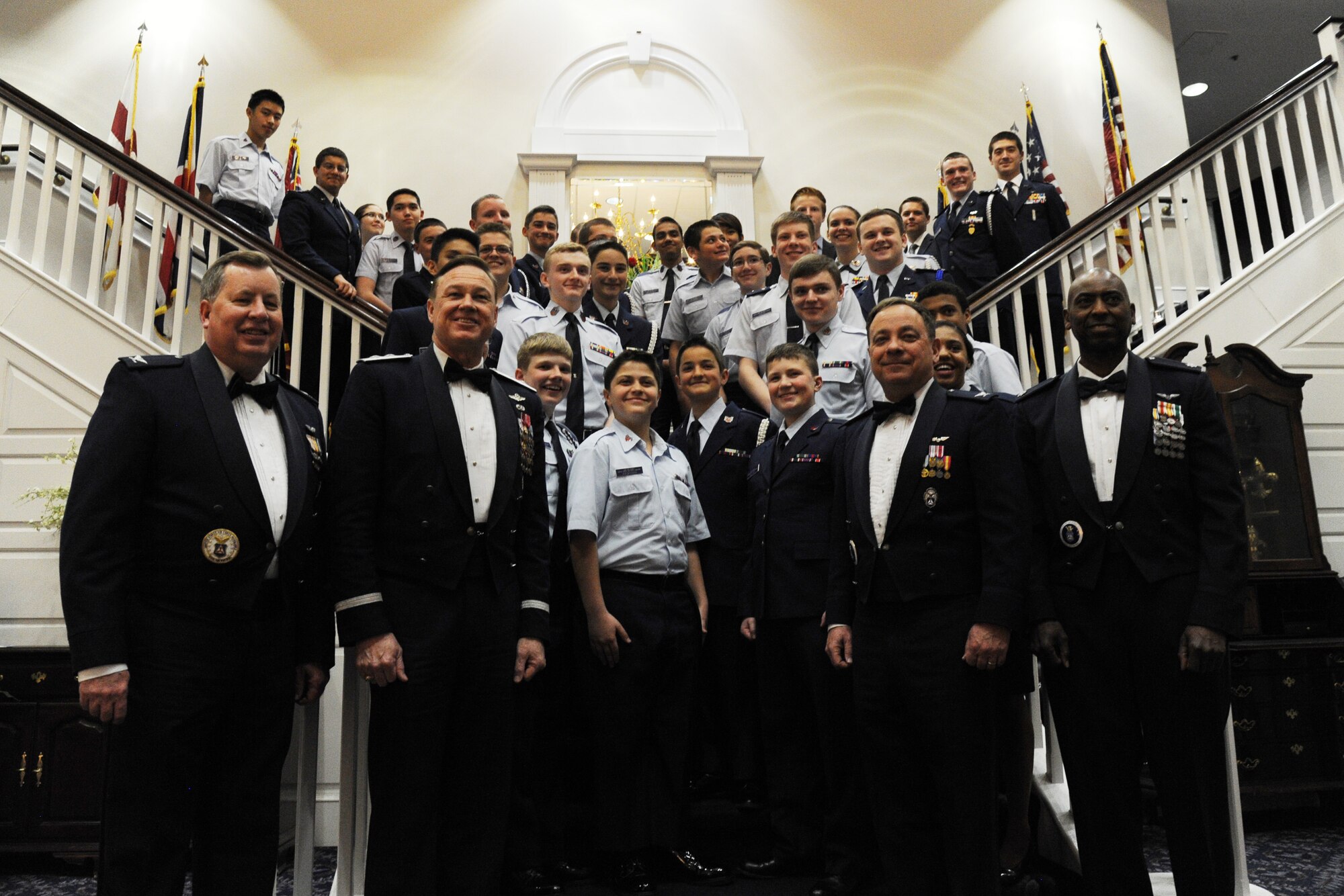 Air Force District of Washington Commander Maj. Gen. Darryl Burke and Civil Air Patrol National Capital Wing Commander Col. Bruce Heinlein pose for a photo with members of the CAPNCW during the 2015 Wing Conference and Banquet at Joint Base Anacostia-Bolling, D.C., March 27, 2015. The CAP directly supports the U.S. Air Force by providing impact assessment, light transport, communications support, and love-level route surveys. In addition, about 10 percent each year’s new U.S. Air Force Academy students are CAP cadets. (U.S. Air Force photo/Master Sgt. Tammie Moore)
