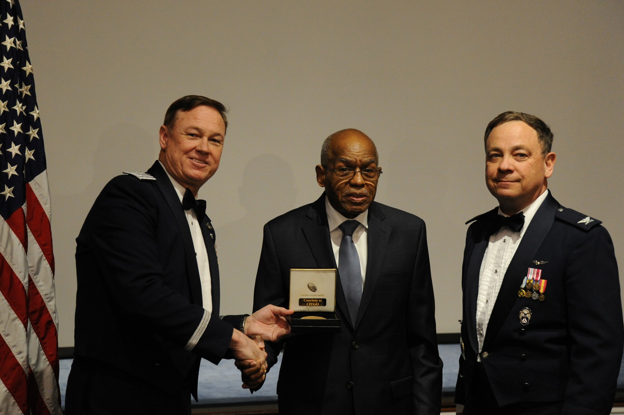 Air Force District of Washington Commander Maj. Gen. Darryl Burke and Civil Air Patrol National Capital Wing Commander Col. Bruce Heinlein present Samuel Harmon with a Congressional Gold Medal during the 2015 Wing Conference and Banquet at Joint Base Anacostia-Bolling, D.C., March 27, 2015. Harmon quit school at age 15 and convinced his local draft broad he was old enough to serve in the military during World War II.  Harmon joined the Navy where he served as a chief electronics technician. (U.S. Air Force photo/Master Sgt. Tammie Moore)