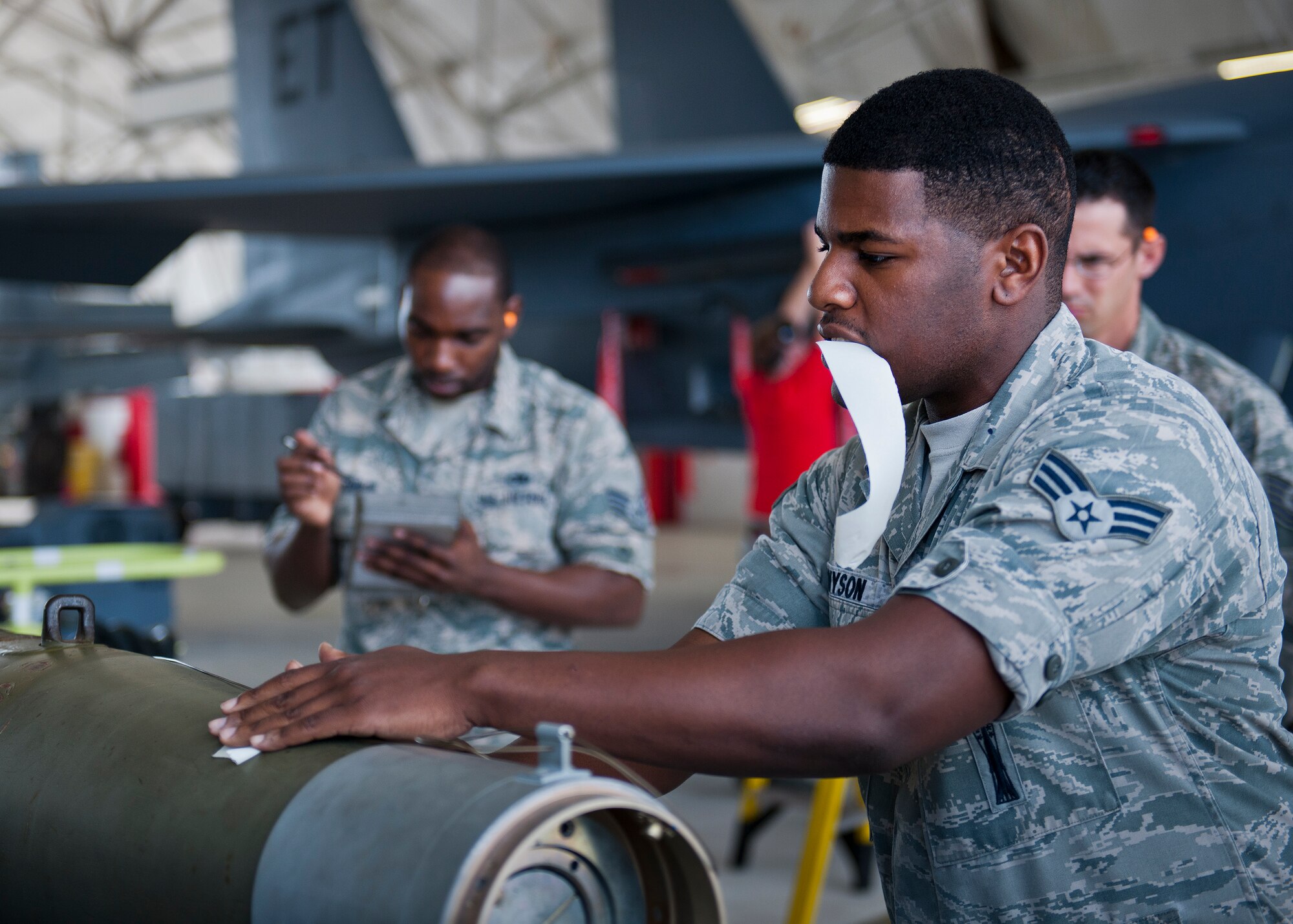 Senior Airman Christopher Tennyson, 96th Aircraft Maintenance Squadron, secures a wire on an MK-82 prior to loading onto an F-16 Fighting Falcon during the squadron’s first quarter weapons load competition March 19 at Eglin Air Force Base, Fla.  The Red F-15 Eagle team battled the Blue F-16 crew for quickest and most accurate load of a bomb and missile on their respective aircraft.  (U.S. Air Force photo/Samuel King Jr.)