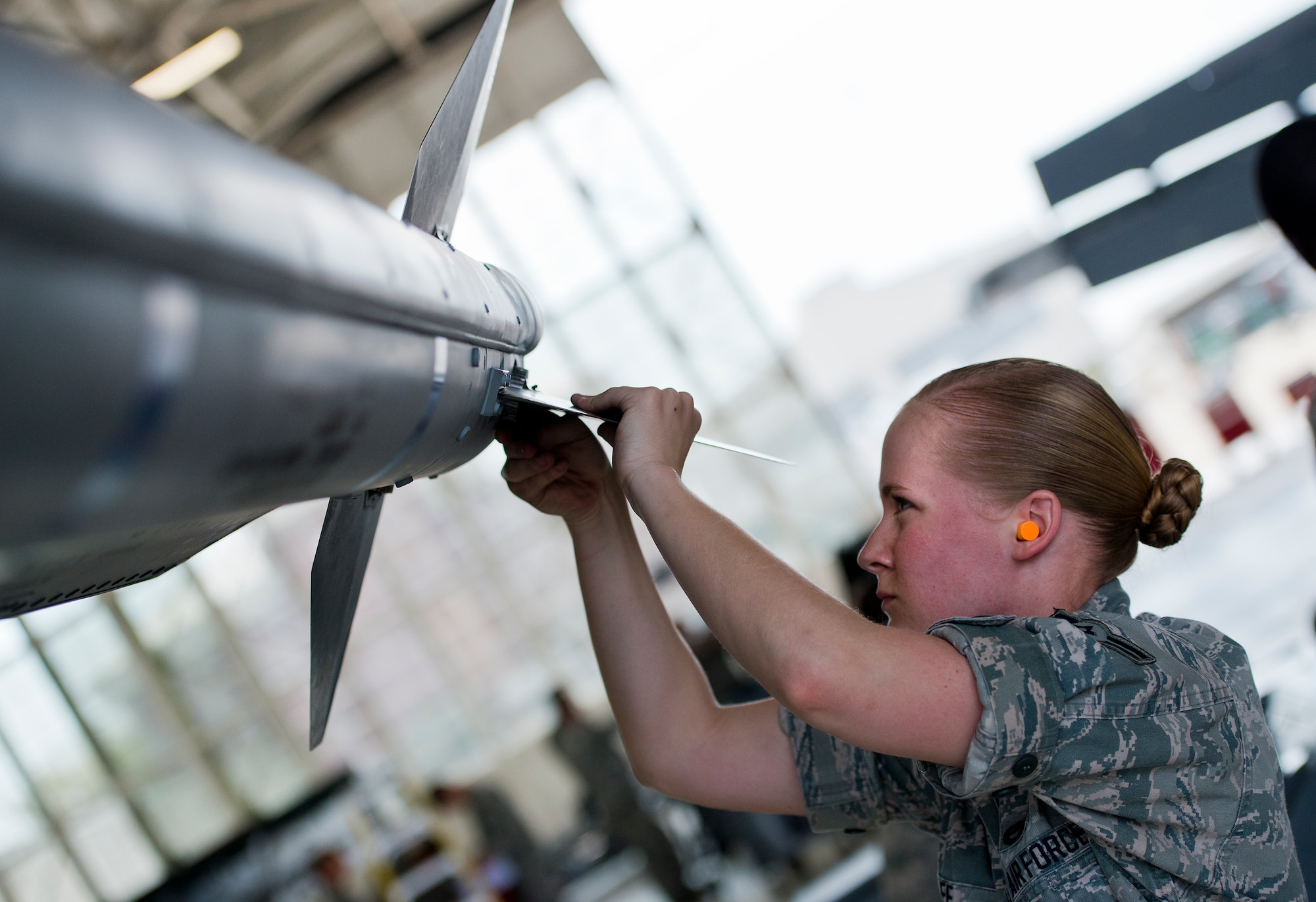 Airman 1st Class Kyndle Lee, 96th Aircraft Maintenance Squadron, secures a fin on a missile loaded to an F-16 Fighting Falcon during the squadron’s first quarter weapons load competition March 19 at Eglin Air Force Base, Fla.  The Red F-15 Eagle team battled the Blue F-16 crew for quickest and most accurate load of a bomb and missile on their respective aircraft.  (U.S. Air Force photo/Samuel King Jr.)