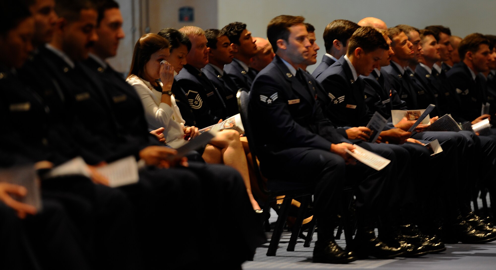 An attendee weeps during Chief Master Sgt. of the Air Force #9 James C. Binnicker’s celebration of life ceremony at the Emerald Coast Convention Center, Fort Walton Beach, Fla., March 28, 2015. During his tenure as the ninth chief master sergeant of the Air Force, Binnicker led the transformation from the Airman Performance Report to the Enlisted Performance Report, and developed the performance feedback system. He also worked to have master sergeants admitted to the Air Force Senior NCO Academy, and to increase the opportunities for minorities and women throughout the Air Force. (U.S. Air Force photo by Airman Kai White/Released)