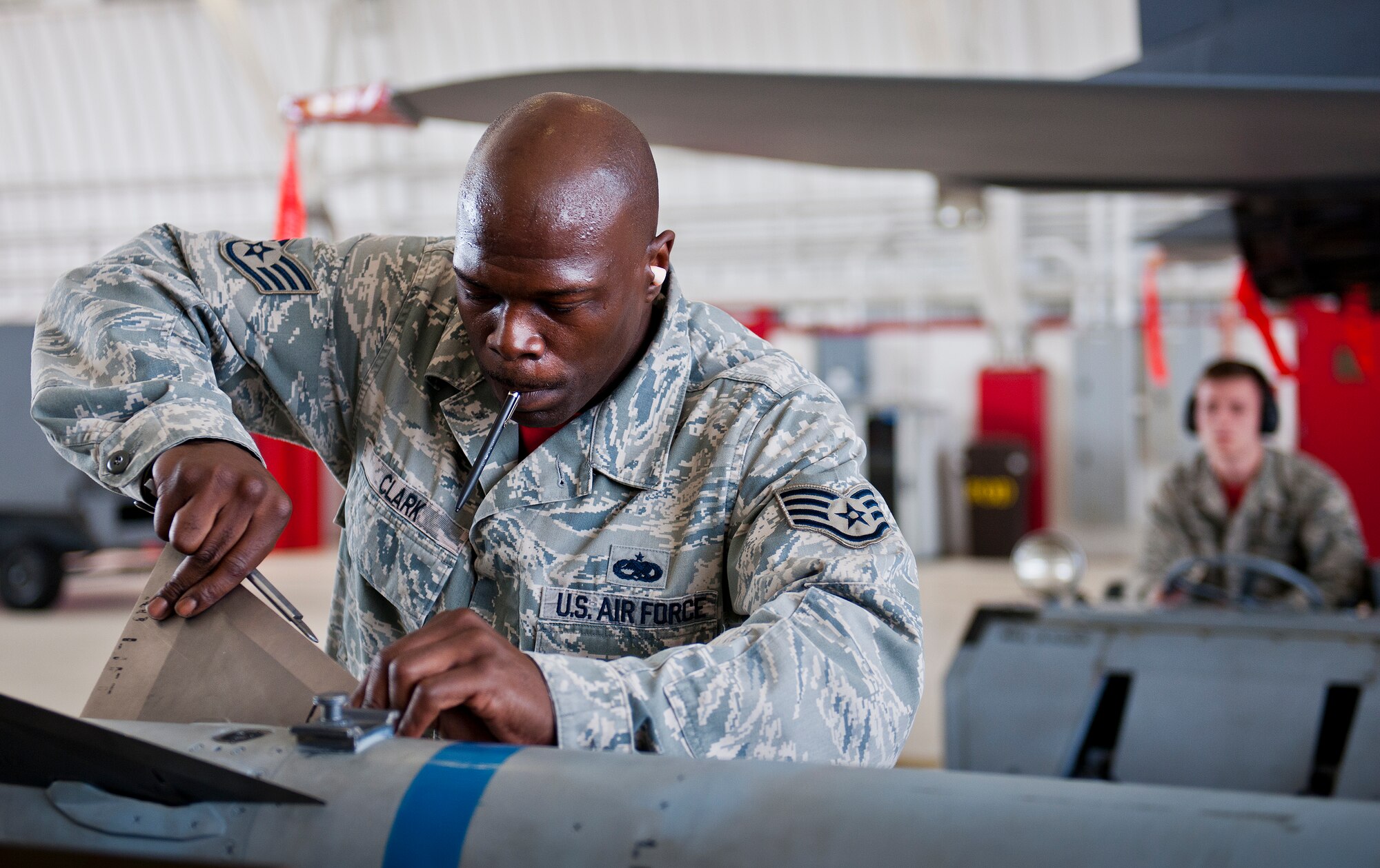 Staff Sgt. Damon Clark, 96th Aircraft Maintenance Squadron, secures a fin on a missile prior to it being loaded to an F-15 Eagle during the squadron’s first quarter weapons load competition March 19 at Eglin Air Force Base, Fla.  The Red F-15 team battled the Blue F-16 Fighting Falcon crew for quickest and most accurate load of a bomb and missile on their respective aircraft.  (U.S. Air Force photo/Samuel King Jr.)