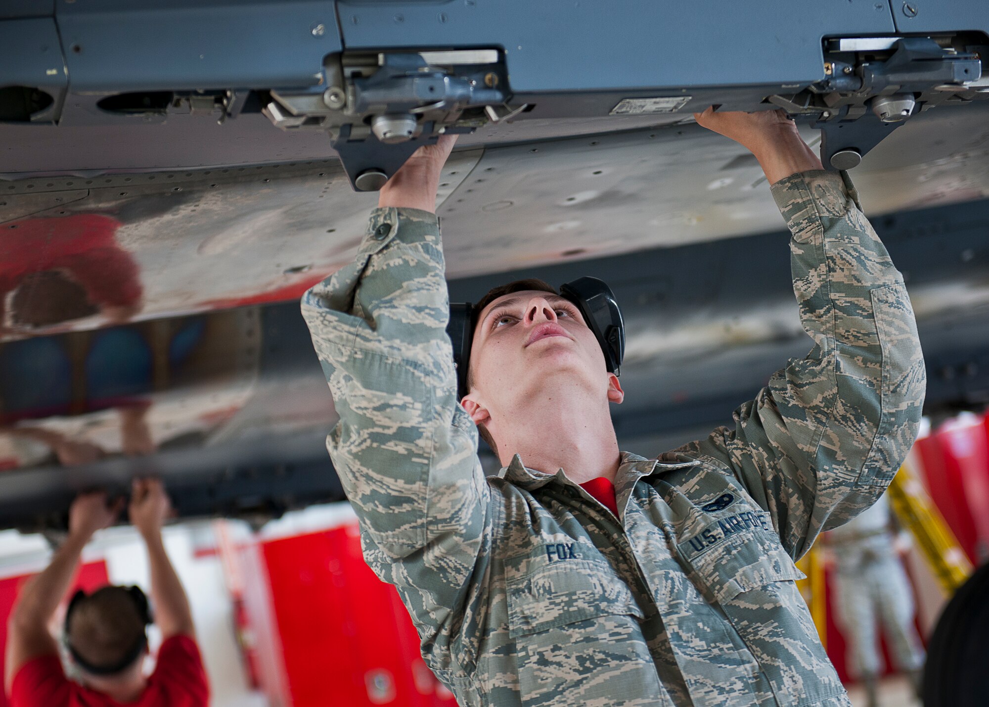 Airman 1st Class Nathan Fox, 96th Aircraft Maintenance Squadron, performs pre-load checks on an F-15 Eagle during the squadron’s first quarter weapons load competition March 19 at Eglin Air Force Base, Fla.  The Red F-15 team battled the Blue F-16 Fighting Falcon crew for quickest and most accurate load of a bomb and missile on their respective aircraft.  (U.S. Air Force photo/Samuel King Jr.)