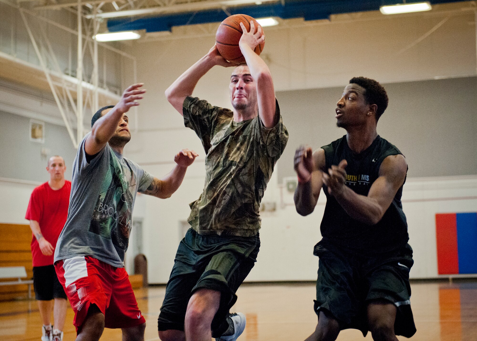 A competitor drives to the basket during a three-on-three tournament held March 20 at Eglin Air Force Base, Fla. A variety of teams battled it out in the double elimination contest. (U.S. Air Force photo/Samuel King Jr.)