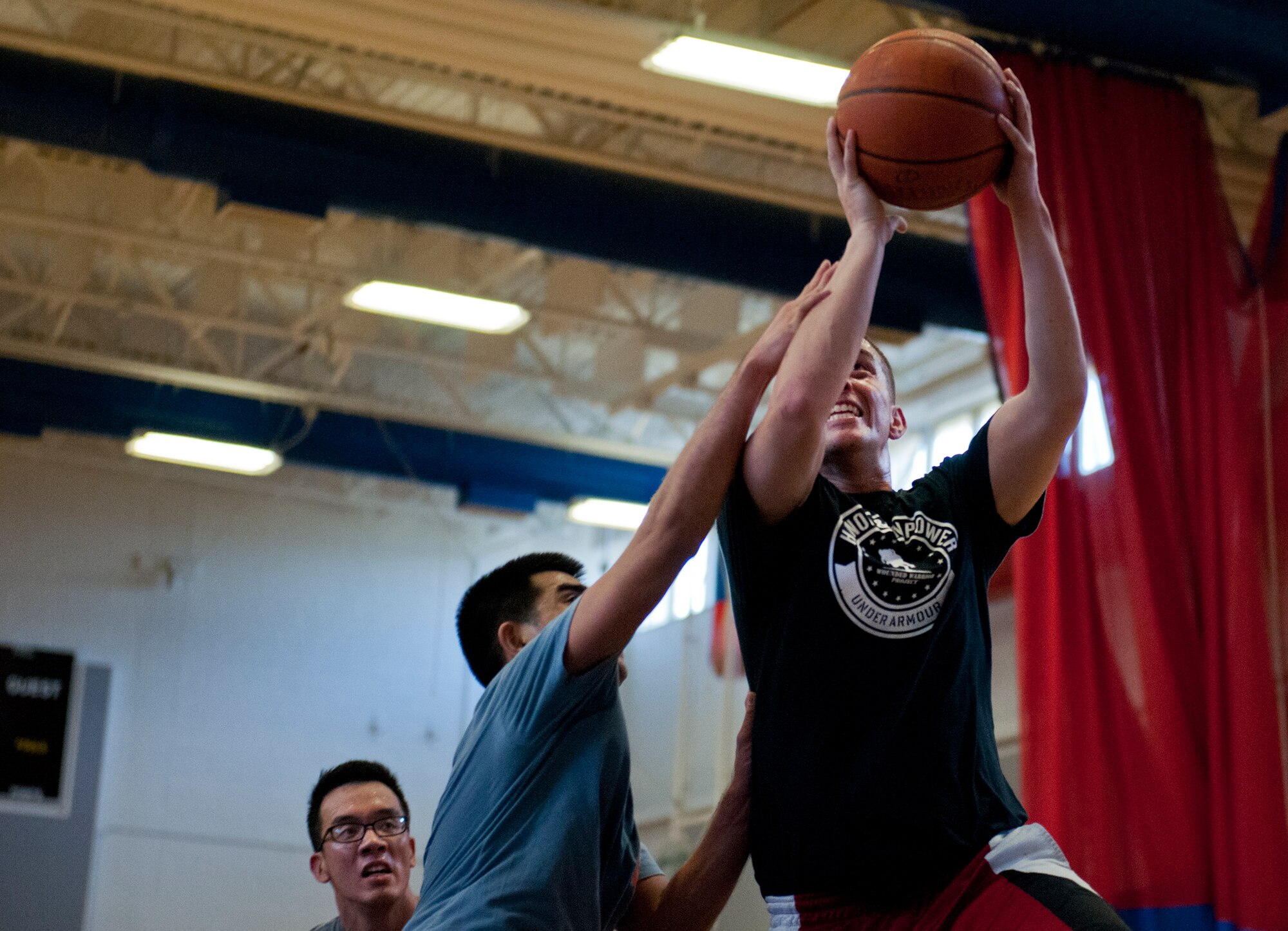 William Sage gets fouled as he drives to the basket during a three-on-three tournament held March 20 at Eglin Air Force Base, Fla. A variety of teams battled it out in the double elimination contest. (U.S. Air Force photo/Samuel King Jr.)