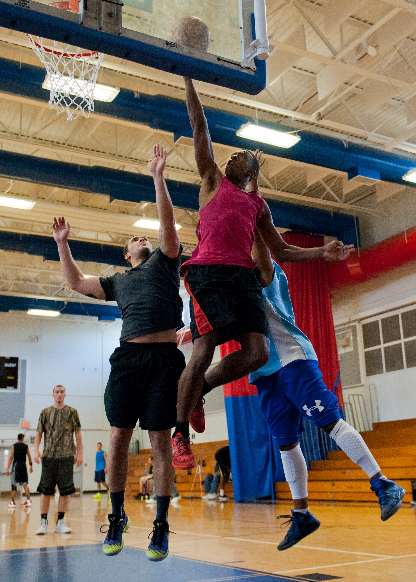 A competitor soars past defenders to the basket during a three-on-three tournament held March 20 at Eglin Air Force Base, Fla. A variety of teams battled it out in the double elimination contest. (U.S. Air Force photo/Samuel King Jr.)