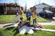 U.S. Air Force Academy cadets collect debris from the streets of Moore, Okla., March 26, 2015. A late-afternoon tornado struck the small community, just outside Oklahoma City, March 25, 2015. Fifteen cadets were in Moore March 23-27 to build homes with Habitat for Humanity as part of their Alternative Spring Break Program. (U.S. Air Force photo/John Van Winkle)
