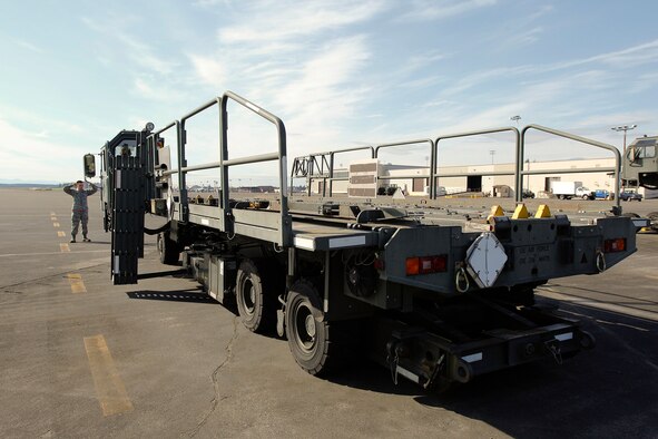 Airman 1st Class Will Akers, 86th Aerial Port Squadron cargo specialist, spots Tech. Sgt. Sarah Ourso, 86th APS load planner, in the Halvorsen Loader, also known as a 25K loader, March 27. Operating and spotting on the Halvorsen is one of the fundamental skill sets new air transportation specialists learn. Both of the Air Force Reserve's aerial port units at McChord Field - 36th and 86th APS - are in the market for new Airmen.(U.S. Air Force Reserve photo by Jake Chappelle)