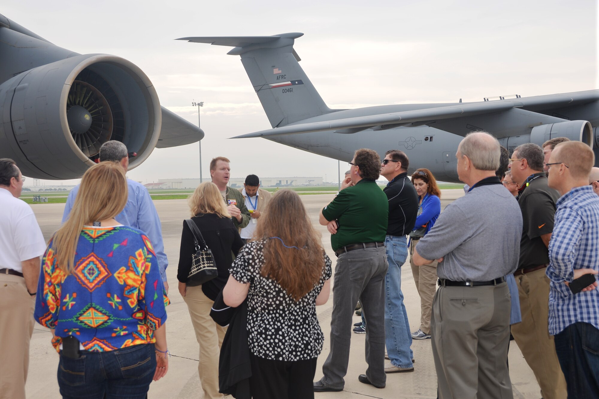 Maj Jonathan Behunin, center, a pilot with the 68th Airlift Squadron, gives an exterior tour of  a C-5A Galaxy aircraft to civic leaders from Tampa, Florida March 20, 2015. The 927th Air Refueling Wing from MacDill Air Force Base, Florida hosted the tour. (U.S. Air Force photo/Minnie Jones)

