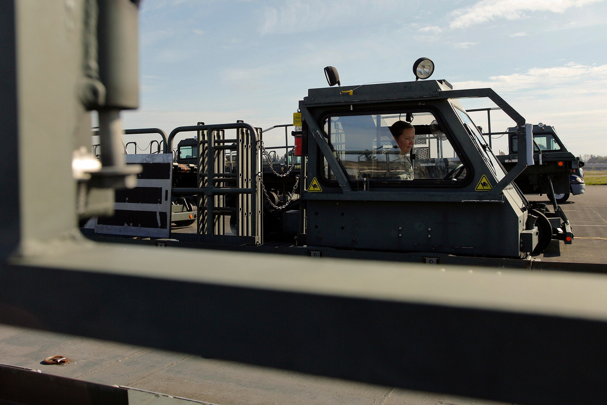 Tech. Sgt. Sarah Ourso, 86th Aerial Port Squadron load planner, out of Joint Base Lewis-McChord, Washington, puts in some on-the-job-training hours on the Halvorsen Loader, also known as a 25K loader March 27. The Halvorsen is a rapidly deployable, high-reach mechanized aircraft loader that can transport and lift up to 25,000 pounds of cargo and load it onto military and civilian aircraft. It's also one of the main vehicles used by aerial port specialists in theater. (U.S. Air Force Reserve photo by Jake Chappelle)