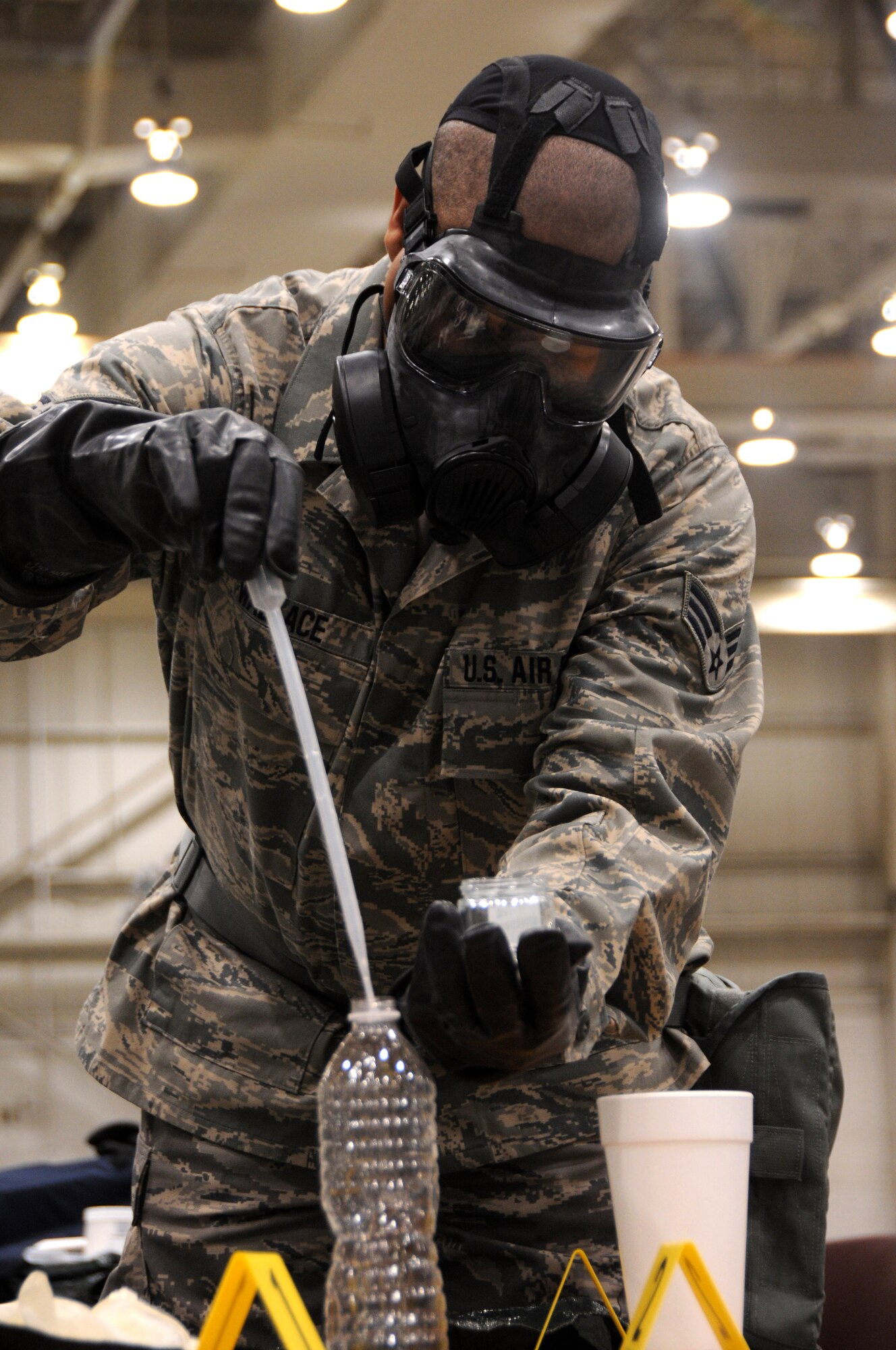 Senior Airman Keenan Wallace, 188th Wing emergency manager, samples unidentified substances during the Global Dragon deployment for training at the Guardian Centers of Georgia, Perry, Georgia, March 10, 2015. Wallace, a member of the 188th Civil Engineer Squadron, was selected at The Flying Razorback Spotlight. The unidentified substances included liquids, powders and gels. Air National Guard emergency management technicians from all 10 Federal Emergency Management Agencies participated in Global Dragon. Wallace was recognized as a top performer during the exercise. (U.S. Air National Guard photo by Senior Airman Cody Martin/released)