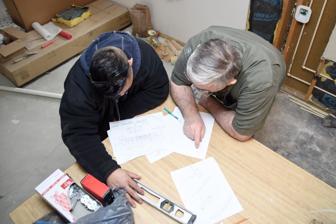 Tech. Sgt. Melvin Mateo, left, and Allen Lewey evaluate blueprints of the kitchen for Mateo’s home in Bowie, Md., Jan. 29, 2015. Mateo is an 89th Communications Squadron Government Network Operations Center crew chief and Lewey is a Church of Jesus Christ of Latter-day Saints missionary. (U.S. Air Force photo/Airman 1st Class Ryan J. Sonnier)