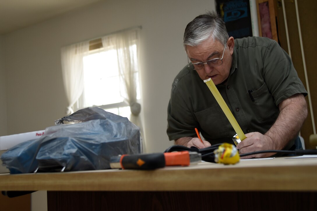 Allen Lewey, Church of Jesus Christ of Latter-day Saints missionary, finished the blueprints of the kitchen layout of a home in Bowie, Md., Jan. 29, 2015. The house belongs to Tech. Sgt. Melvin Mateo, an 89th Communications Squadron Government Network Operations Center crew chief. The home is being renovated to meet the requirements of his special-needs daughter. (U.S. Air Force photo/Airman 1st Class Ryan J. Sonnier)