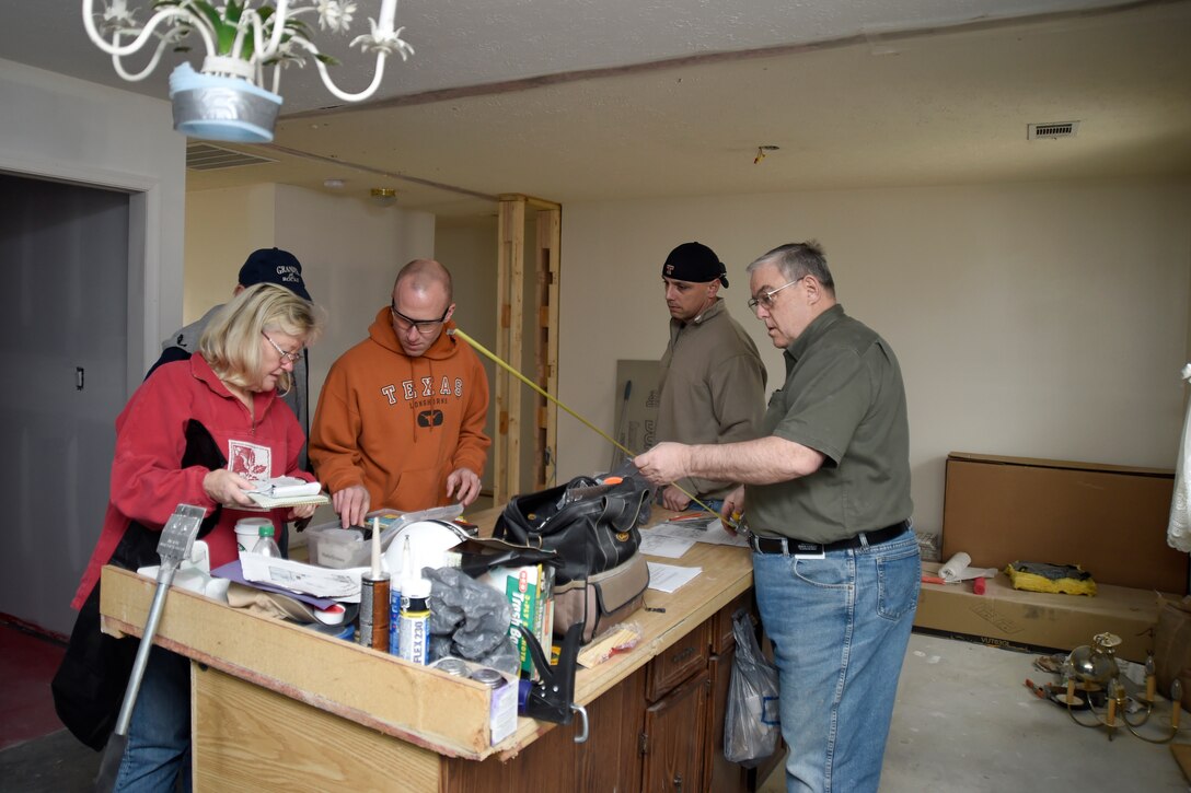 Joint Base Andrews volunteers gather equipment in preparation for home renovations in Bowie, Md., Jan. 29, 2015. Members gathered to help fix Tech. Sgt. Melvin Mateo’s home for his special-needs daughter. Mateo is an 89th Communications Squadron Government Network Operations Center crew chief. (U.S. Air Force photo/Airman 1st Class Ryan J. Sonnier)