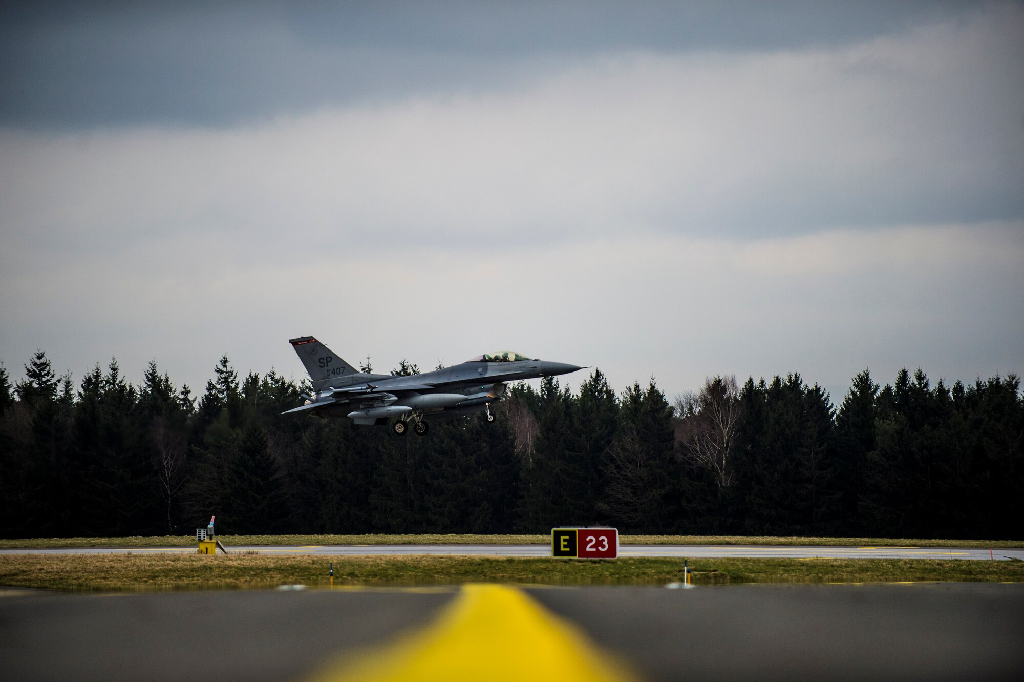 An F-16 Fighter Falcon fighter aircraft assigned to the 480th Fighter Squadron prepares to land on the runway at Spangdahlem Air Base, Germany, March 27, 2015. The aircraft was one of six that returned from Campia Turzii, Romania, in support of exercise Dacian Warhawk 2015, a bilateral training with the Romanian air force. (U.S. Air Force photo by Airman 1st Class Luke Kitterman/Released)