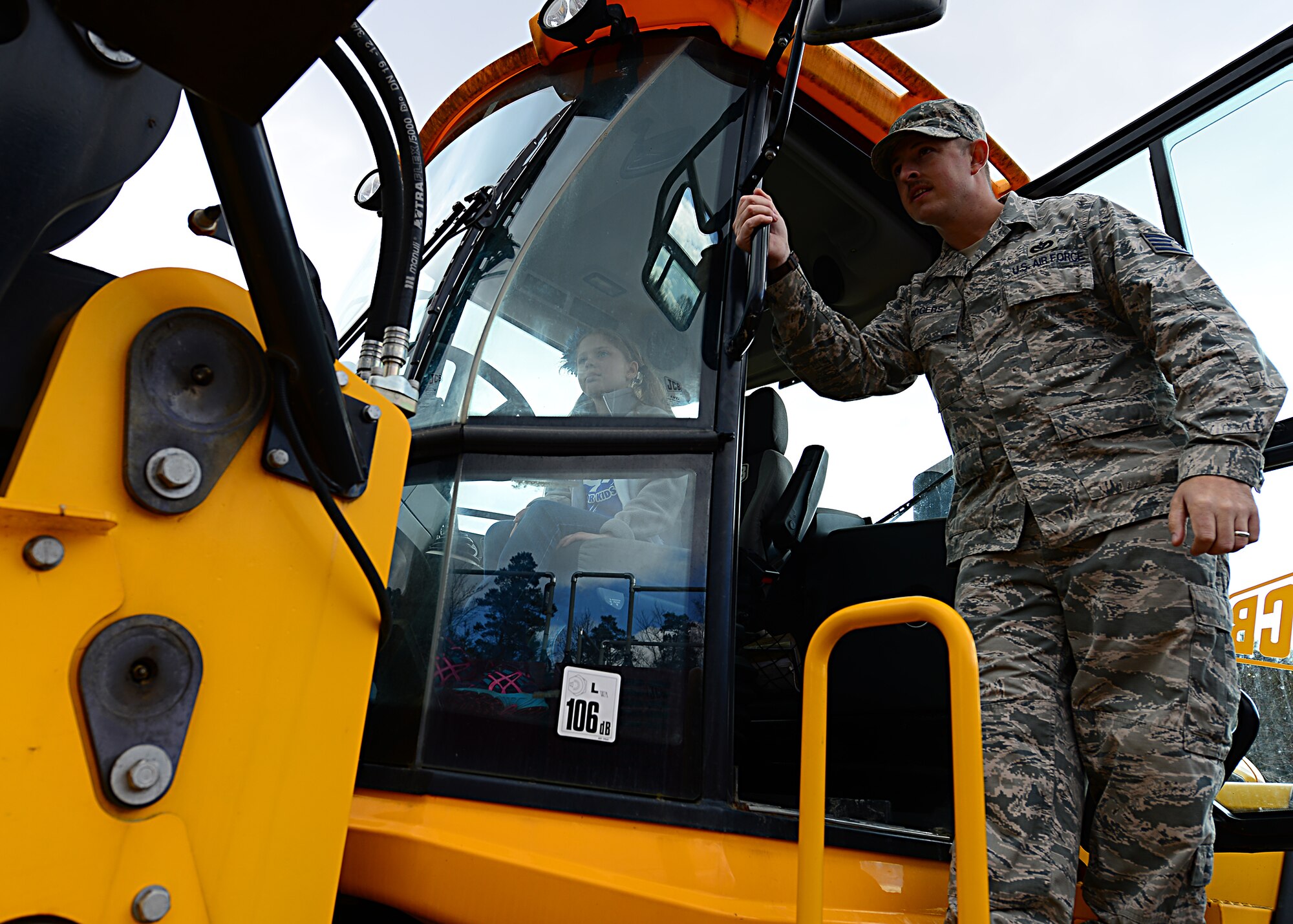 Staff Sgt. Len Rogers, 435th Construction and Training Squadron heavy equipment and pavement contingency instructor teaches Alexandra Bertolucci a Ramstein Intermediate School student how to operate a bulldozer during a mock pre-deployment line held on the 435th Air Ground and Operations Wing, 435th Construction and Training Squadron’s silver flag compound, March 27, 2015.  Ramstein units came together and gave RIS students the opportunity to deploy like their Airmen and Soldier parents. (U.S. Air Force photo/Tech. Sgt. Daylena S. Ricks)
