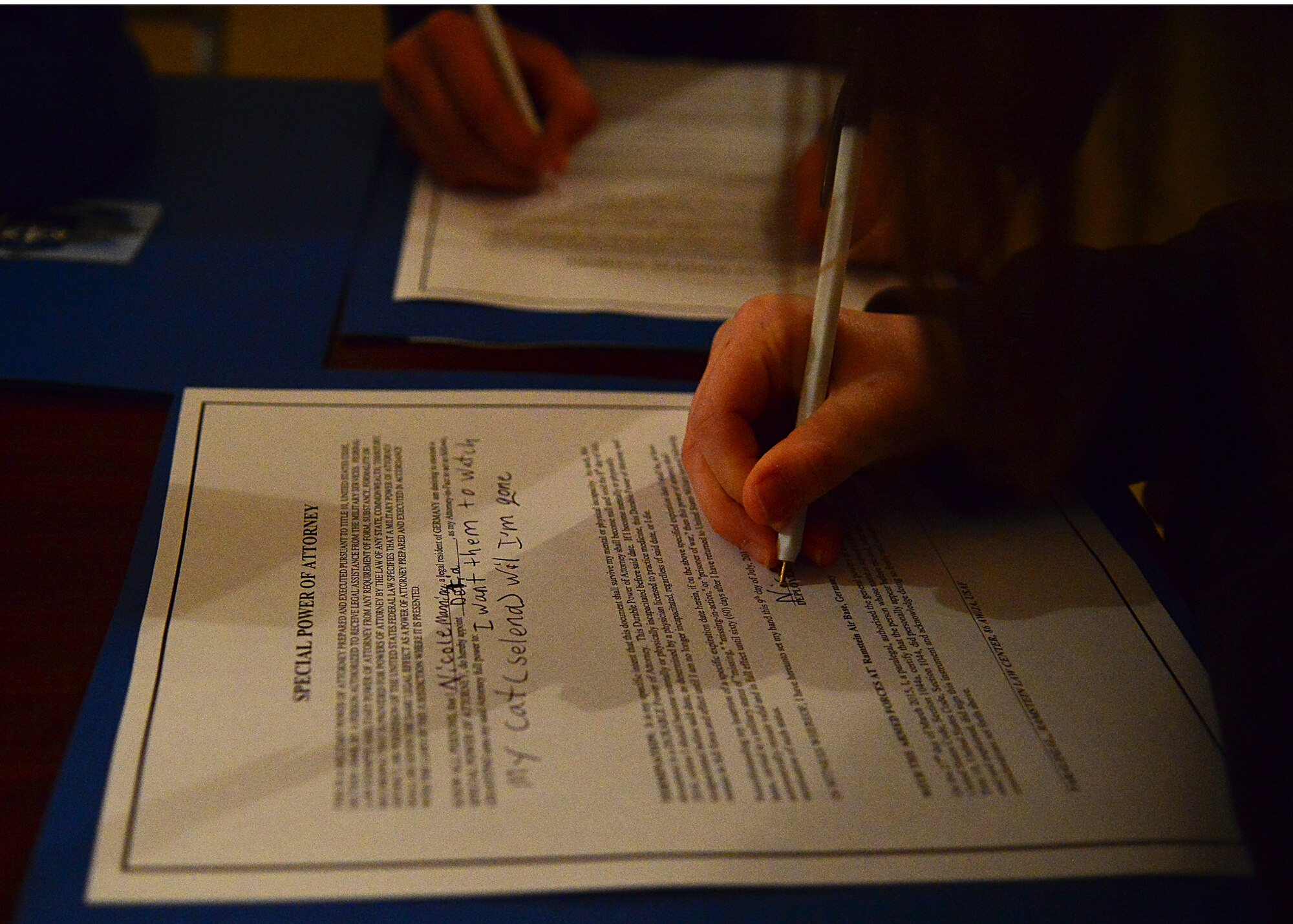 Ramstein Intermediate School student completes and signs a special power of attorney during a mock pre-deployment line held on the 435th Air Ground and Operations Wing, 435th Construction and Training Squadron’s silver flag compound, March 27, 2015.  . (U.S. Air Force photo/Tech. Sgt. Daylena S. Ricks)