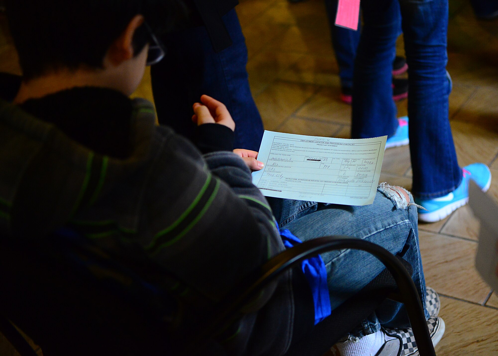 A Ramstein Intermediate School student is assigned to a squadron during a mock pre-deployment line held on the 435th Air Ground and Operations Wing, 435th Construction and Training Squadron’s silver flag compound, March 27, 2015.  Ramstein units came together and gave RIS students the opportunity to deploy like their Airmen and Soldier parents. (U.S. Air Force photo/Tech. Sgt. Daylena S. Ricks)