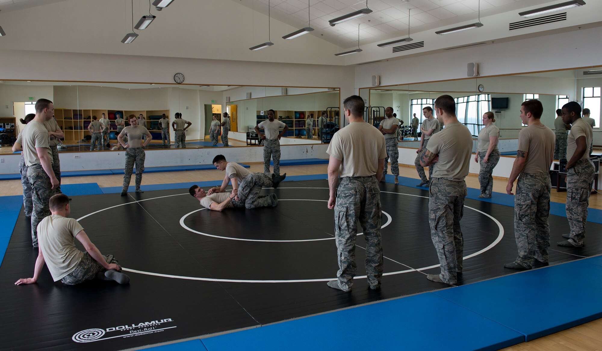 Tech. Sgt. Chance Farmer, 65th Security Forces Squadron noncommissioned officer in charge of training, shows members of the 65th SFS combatives moves at the Chace Fitness Center on Lajes Field, Azores Portugal, March 24, 2015. This training helps hone members' close-quarters combat techniques and this class will certify them in security forces combatives. (U.S. Air Force photo/Staff Sgt. Zachary Wolf)
