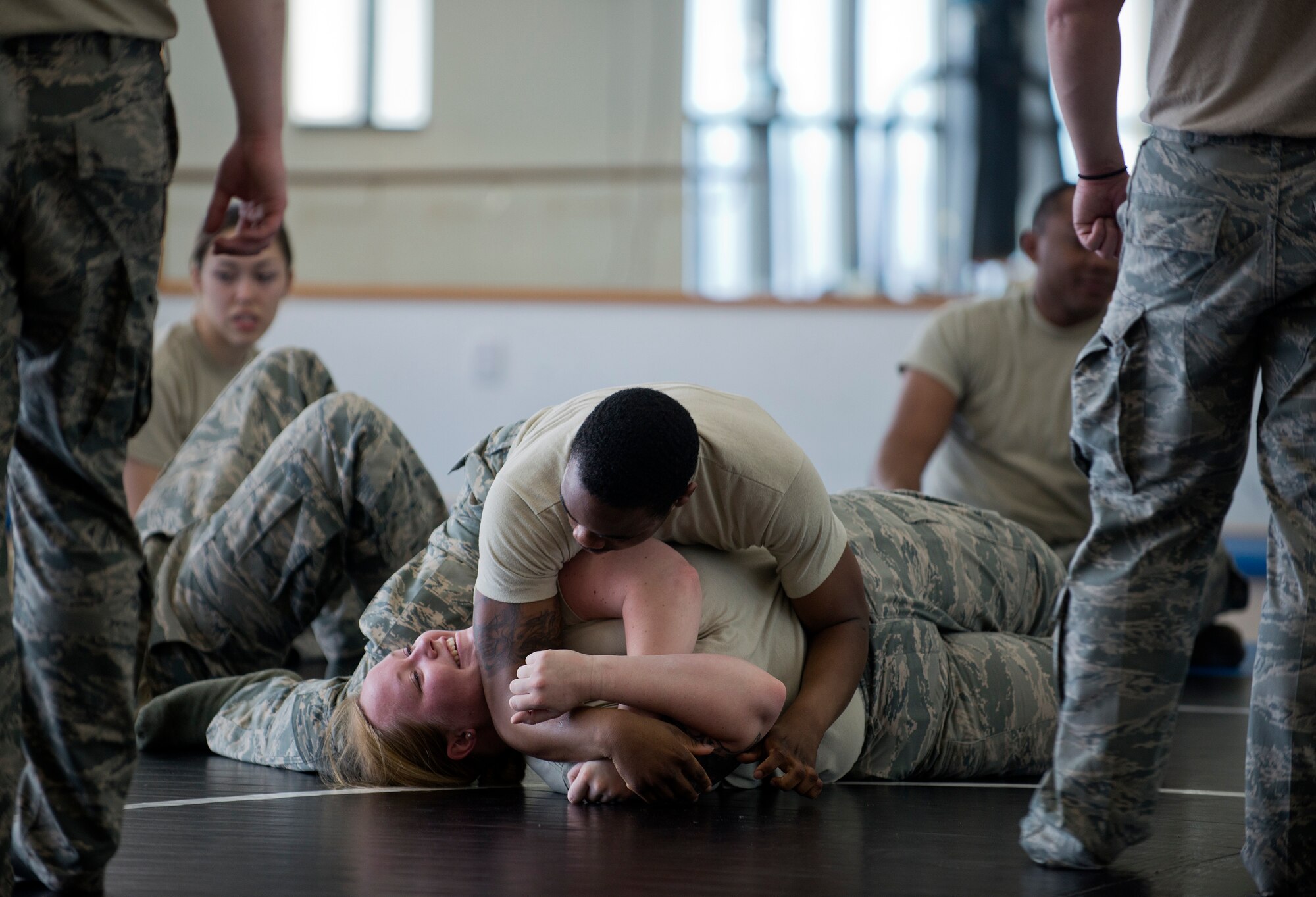 Airman 1st Class Kelsey Stauffacher, 65th Security Forces Squadron base defense operations center controller, breaks out of a hold that Senior Airman Cedric Washington, 65th SFS flight chief, has her in during combatives training at the Chace Fitness Center on Lajes Field, Azores Portugal, March 24, 2015. This training helps hone members' close-quarters combat techniques and this class will certify them in security forces combatives. (U.S. Air Force photo/Staff Sgt. Zachary Wolf)