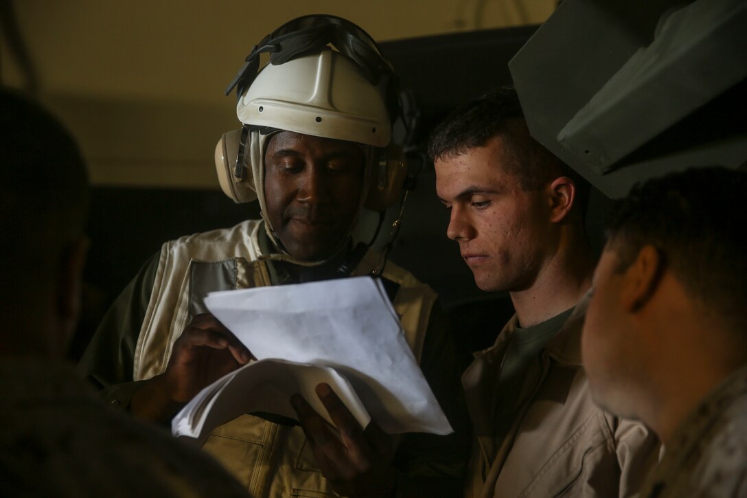 U.S. Marines with the 15th Marine Expeditionary Unit look over a manifest before loading Marines and gear onto a landing craft, air cushion during Composite Training Unit Exercise off the coast of San Diego, March 27, 2015. The combat cargo Marines are responsible for the accountability of everything that arrives and departs the ship. (U.S. Marine Corps photo by Cpl. Anna Albrecht/Released)