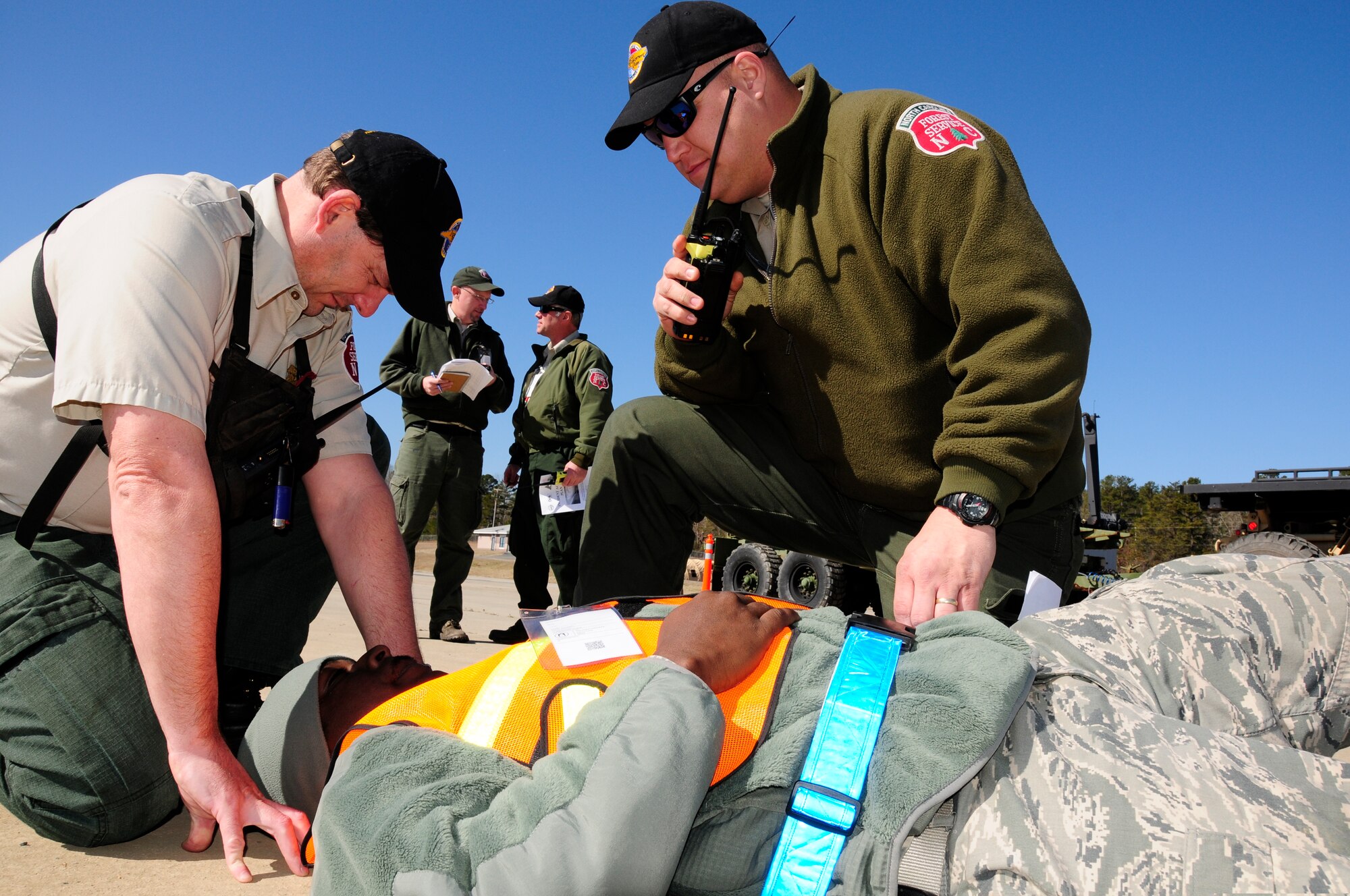 North Carolina Forest Service first responders assess a patient’s simulated injury during Vigilant Guard 2015 exercise held at the 145th Civil Engineer Squadron-Regional Training Site in New London, N.C., March 6-8, 2015. Vigilant Guard is an exercise that provides an opportunity for Army and Air National Guard, North Carolina Emergency Management and county civilian partners to come together to train as true partners in order to respond effectively to natural disasters. (U.S. Air National Guard photo by Master Sgt. Patricia F. Moran, 145th Public Affairs/Released)
