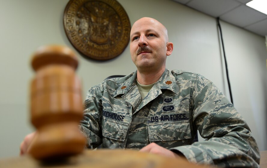 Maj. Ronald Roodhouse, 51st Fighter Wing Judge Advocate Office deputy staff judge advocate, holds a gavel in the court room March 26, 2014, at Osan Air Base, Republic of Korea. Roodhouse nicknamed his mustache the perjury detector. (U.S. Air Force photo by Senior Airman David Owsianka)