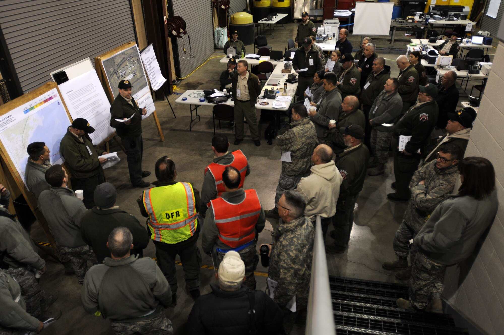 Members of the North Carolina Air and Army National Guard, state Division of Emergency Management and North Carolina Forest Service gather for a morning briefing to cover general control objectives for the incident scenario during the 2015 Vigilant Guard Exercise, March 7, 2015. This exercise, held March 6-8, 2015 at the 145th Civil Engineer Squadron Regional Training Site, New London, N.C., is designed to measure the effectiveness of National Guard forces supporting civilian activities following a hurricane. (U.S. Air National Guard photo by Staff Sgt. Julianne M. Showalter, 145th Public Affairs/Released)