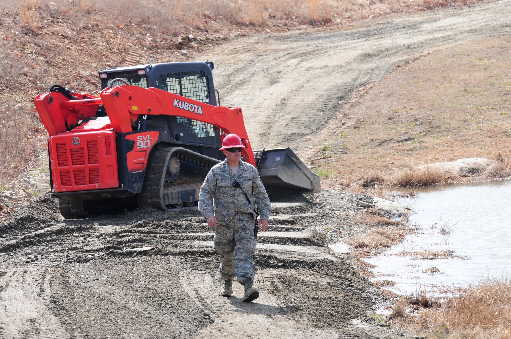 U.S. Air Force Master Sgt. Ronald F. Helms, Jr., 145th Civil Engineer Squadron, returns to “tent city” area after inspecting repairs of washed out road at the 145 CES Regional Training Site, New London, N.C., March 4, 2015. This real-world incident was carried out in order to allow access to the force beddown area where over 200 military and civilian personal will call home during Vigilant Guard 2015. Vigilant Guard is an exercise that provides an opportunity for Army and Air National Guard, North Carolina Emergency Management and county civilian partners to come together to train as true partners in order to respond effectively to natural disasters. (U.S. Air National Guard photo by Master Sgt. Patricia F. Moran, 145th Public Affairs/Released)