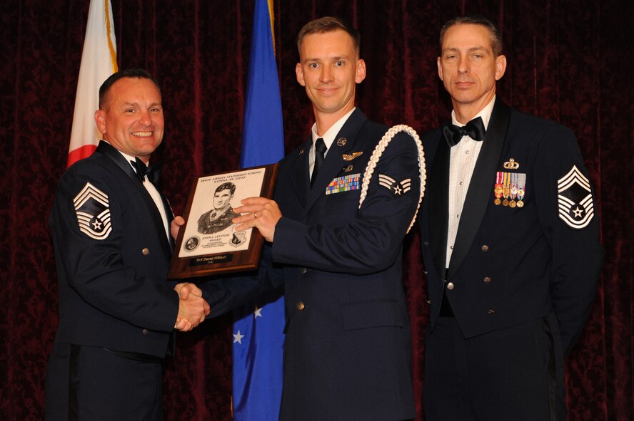 U.S. Air Force Senior Airman David Hibbett, 390th Intelligence Squadron and Airman Leadership School graduate, receives the John L. Levitow Award during the Airman Leadership School graduation ceremony on Kadena Air Base, Japan, March 27, 2015. This award is presented to the student who earns the highest average score on evaluations and most embodies the Air Force core values. (U.S. Air Force photo by Airman 1st Class Stephen G. Eigel)