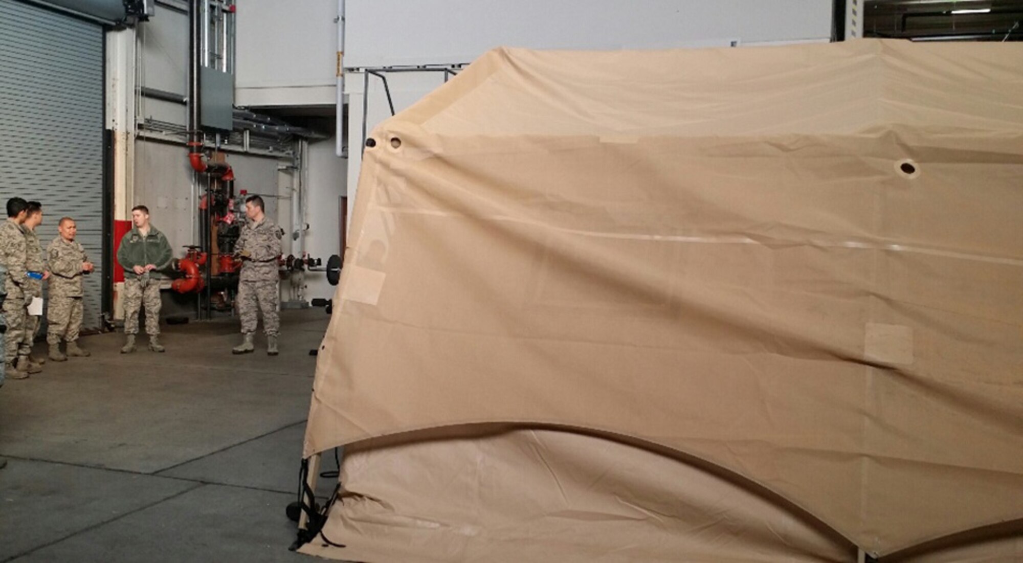 Members of the 446th Aeromedical Staging Squadron, Joint Base Lewis-McChord, Washington get their first look at their new UTILS Tent that will help the squadron members to train locally. (Courtesy photo)