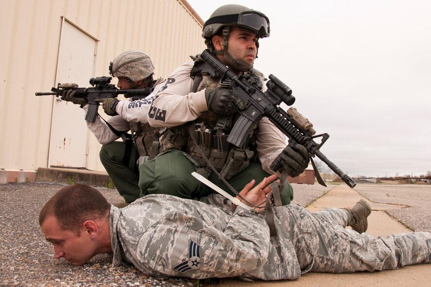 Staff Sgt. Aldo Felici, who is a member of the 2nd Security Forces Squadron’s Emergency Services Team, keeps a watchful eye over the final simulated suspect until he can be turned over to security forces personnel during an Active Shooter Exercise at Barksdale Air Force Base, La., March 20, 2015. The apprehension of the portrayed suspect brought an end the shooting incident during Barksdale’s active shooter exercise. (U.S. Air Force photo by Master Sgt. Jeff Walston)