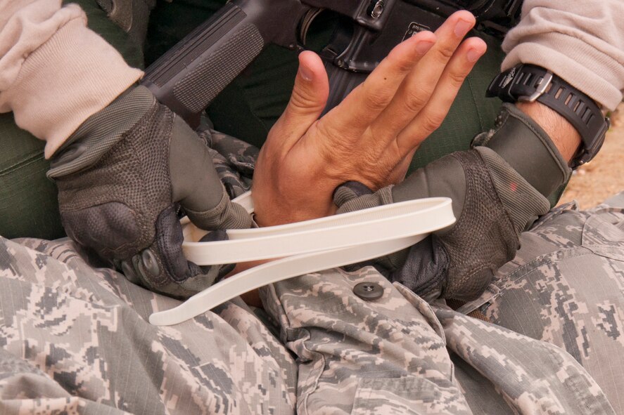 A portrayed gunman’s hands are bound after he surrenders during an Active Shooter Exercise in the 307th RED HORSE compound at Barksdale Air Force Base, La., March 20, 2015. The exercise allowed 2nd Security Forces Squadron personnel to demonstrate appropriate actions/techniques to respond to, control, and neutralize an active shooter scenario while taking into account public safety, site security, crime scene integrity and coordinating support agency involvement. (U.S. Air Force photo by Master Sgt. Jeff Walston)