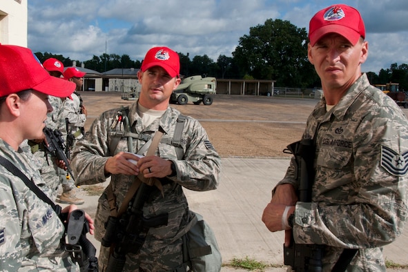 Staff Sgt. Kenneth McMillen, (center), a structural carpenter assigned to the 307th RED HORSE Squadron, instructs a group of Airmen on proper procedures for clearing buildings during a training exercise at Barksdale Air Force Base, La., Sept. 10, 2014. McMillen, who is also a Bowie County Sheriff’s deputy, has been credited with saving the life of a woman in a house fire on March 9, 2015. (U.S. Air Force photo/Master Sgt. Jeff Walston)