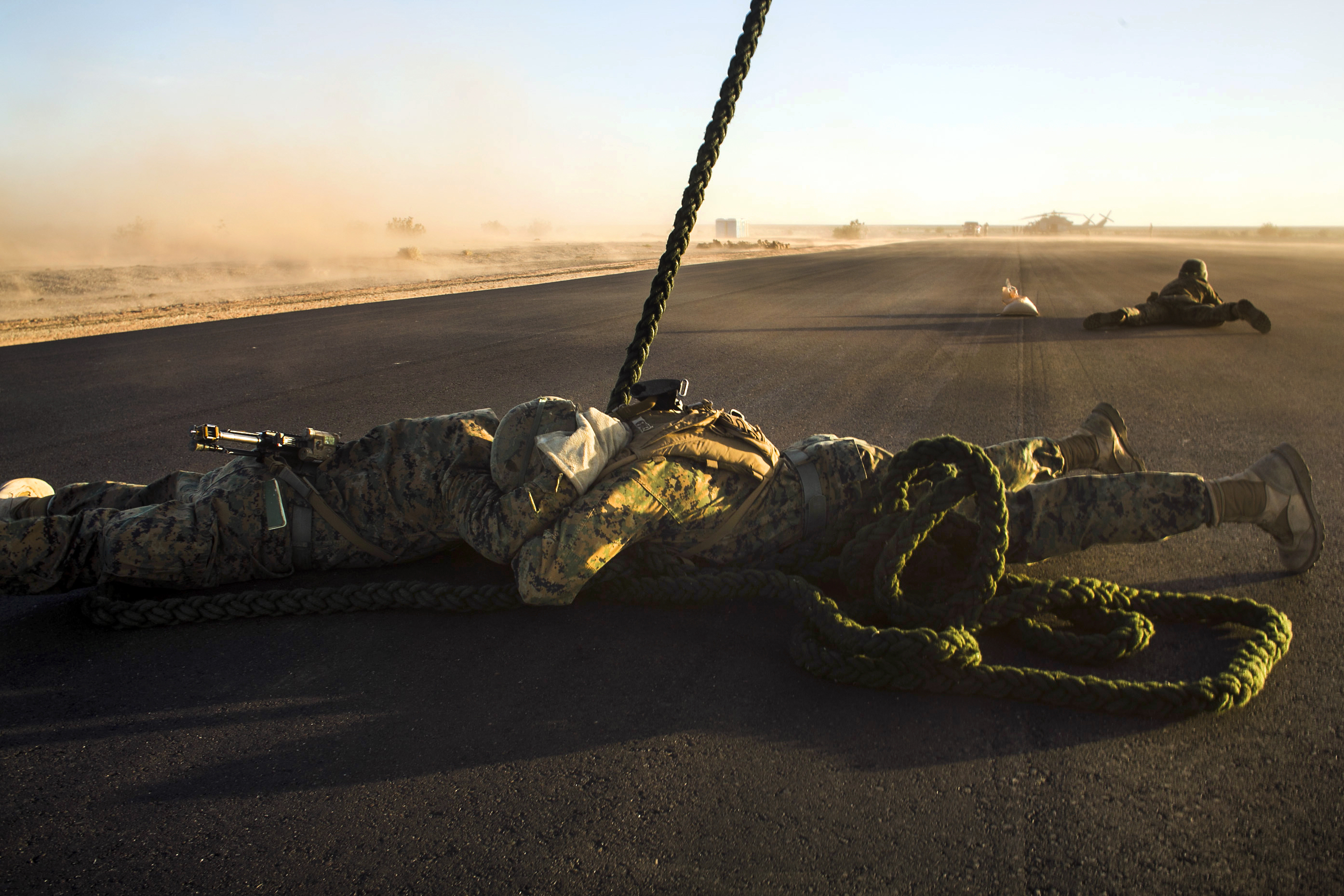 Marines attending the infantry officers course secure a rappel rope during fast  rope training in preparation