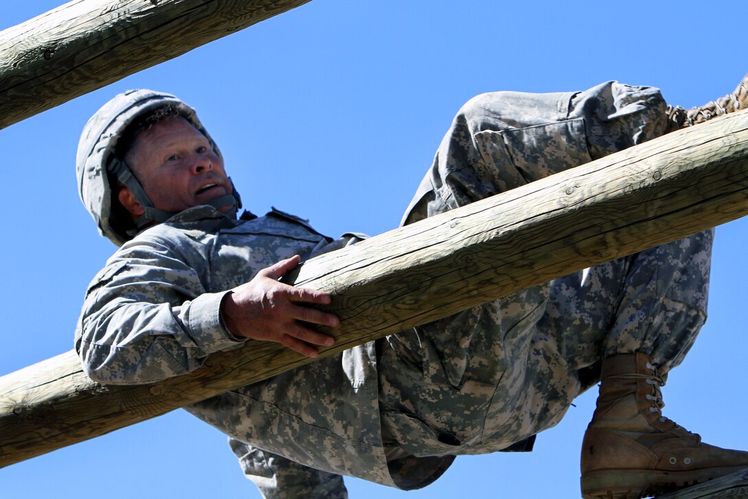 Army Staff Sgt. John Lueke conquers the over and under logs on the confidence course during the 2015 Best Warrior and Drill Sergeant of the Year Competition on Fort Huachuca, AZ., March 27, 2015. Lueke is assigned to the 98th Training Division.
