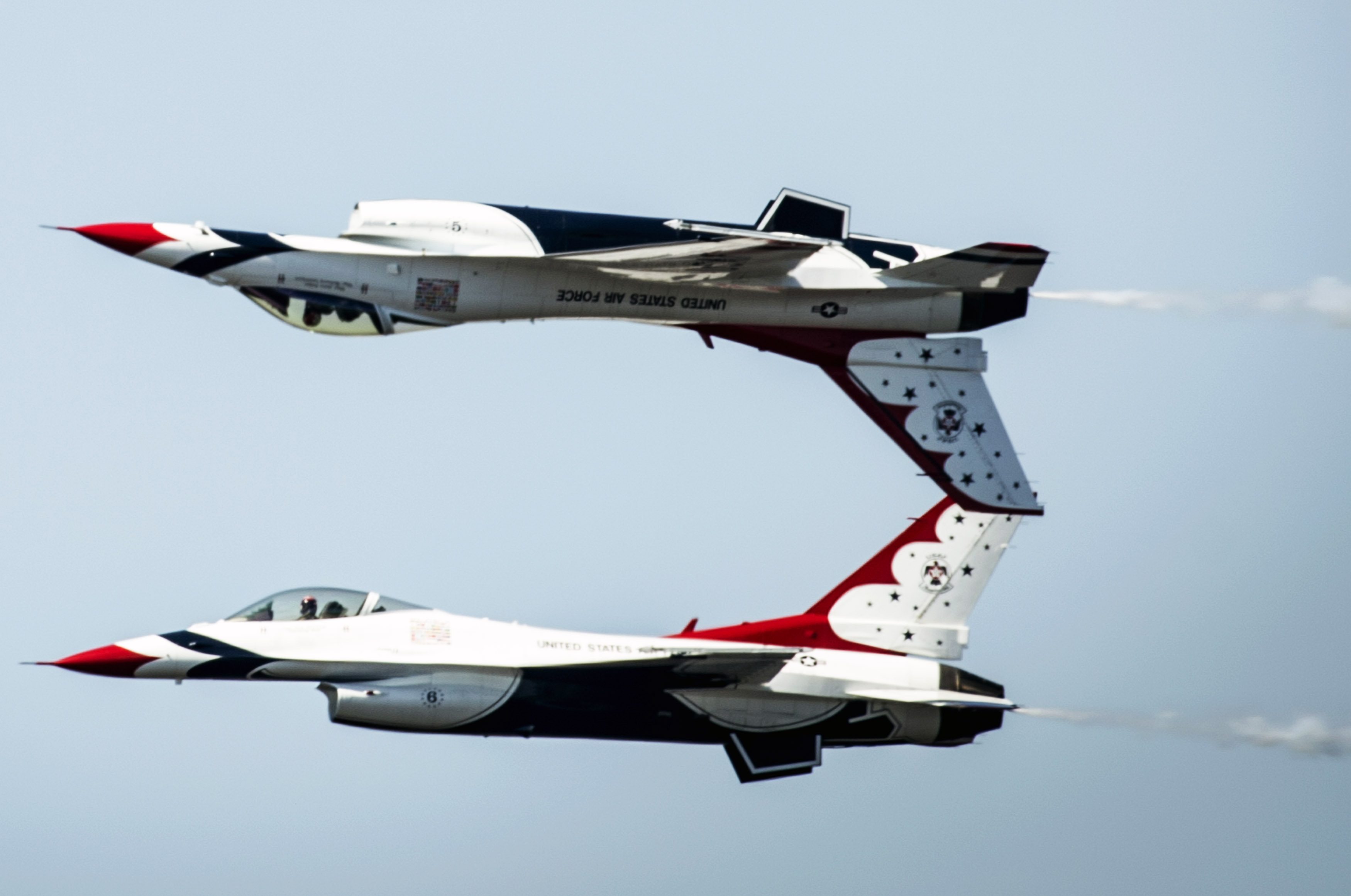 The Thunderbirds Solo pilots perform the Calypso maneuver during the