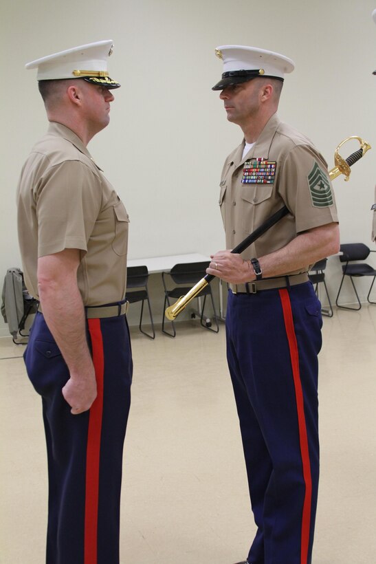 U.S. Marine Corps Sgt. Maj. William E. Sweeney, right, a native of Loveland, Colorado, prepares to pass the noncommissioned officer sword to U.S. Marine Corps Maj. Paul B. Bock, Recruiting Station Frederick Commanding Officer, during a relief and appointment ceremony at Fort Detrick, Maryland, March 26, 2015. The sword is passed from one sergeant major to the next, signifying the transfer of sacred trust. During the ceremony, Sweeney relinquished his post as Marine Corps Recruiting Station Frederick Sergeant Major to Sgt. Maj. Alonzo P. Baxter of Center Cross, Virginia. (U.S. Marine Corps photo by Sgt. Anthony J. Kirby/Released)