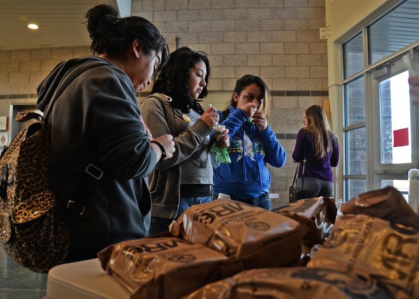 Students sample Meals, Ready to Eat at the Math in the Military event March 26, 2015 at Gattis Middle School in Clovis, N.M. The event offered a hands-on approach to show how math is used every day. (U.S. Air Force photo/Airman 1st Class Chip Slack) 